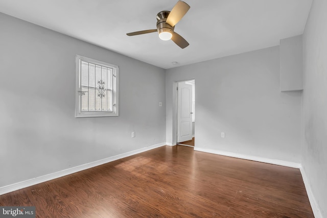 empty room featuring dark hardwood / wood-style floors and ceiling fan