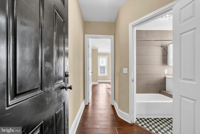 interior space with hardwood / wood-style floors and tiled shower / bath combo