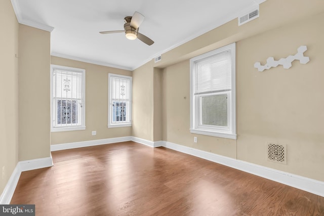 unfurnished room featuring hardwood / wood-style flooring, ceiling fan, and crown molding