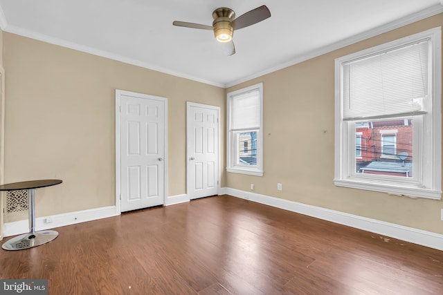 unfurnished bedroom featuring dark hardwood / wood-style floors, ceiling fan, and ornamental molding