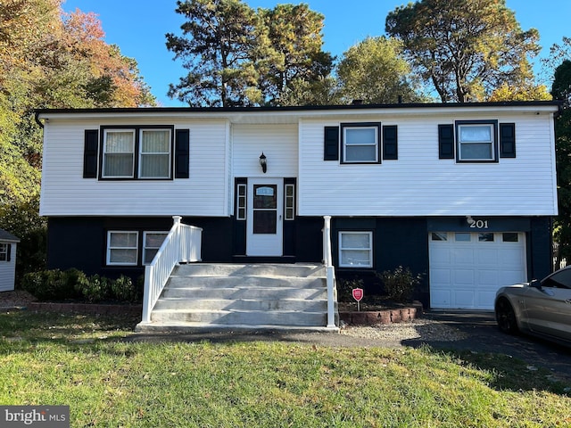 split foyer home with a front yard and a garage