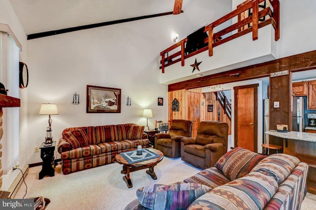 living room with high vaulted ceiling and carpet