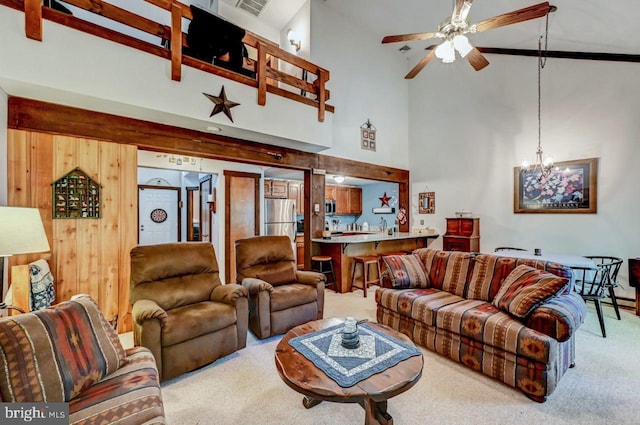 living room featuring light carpet, high vaulted ceiling, and ceiling fan with notable chandelier