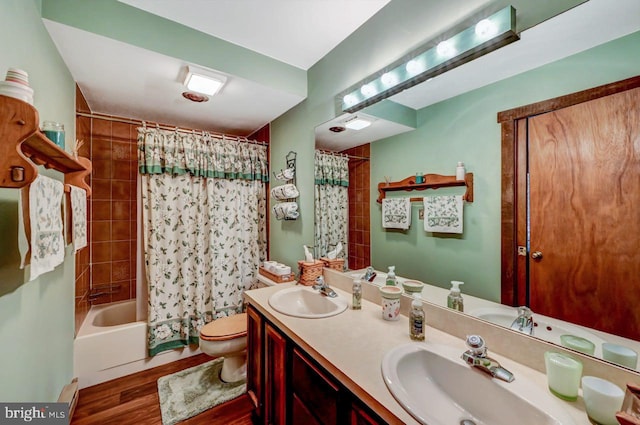 full bathroom with toilet, hardwood / wood-style floors, vanity, and shower / bathtub combination with curtain