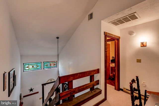 staircase with carpet flooring and lofted ceiling