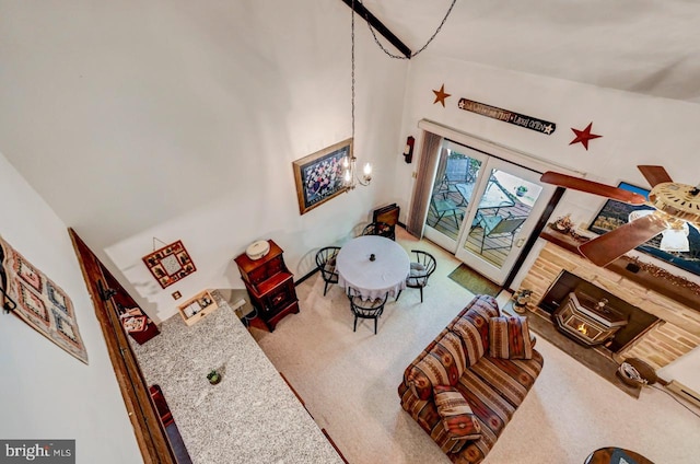 carpeted living room featuring high vaulted ceiling