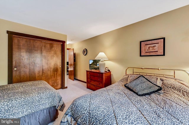 carpeted bedroom with a closet