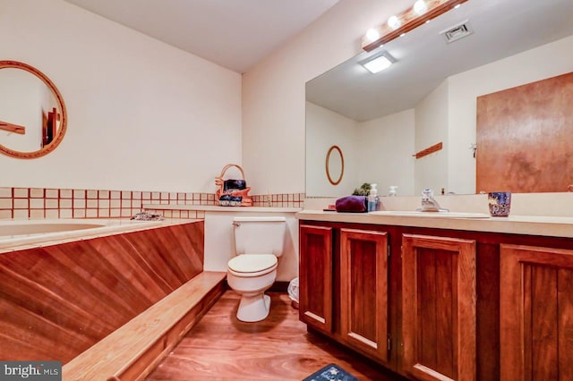 bathroom featuring vanity, hardwood / wood-style floors, and toilet