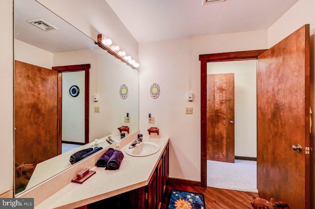 bathroom featuring vanity and hardwood / wood-style floors