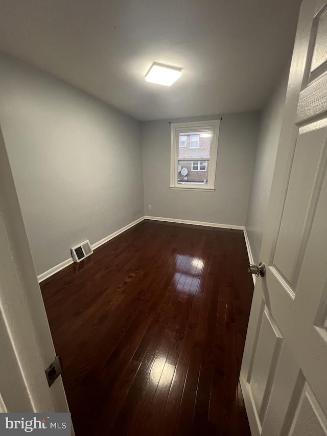 empty room with dark hardwood / wood-style floors