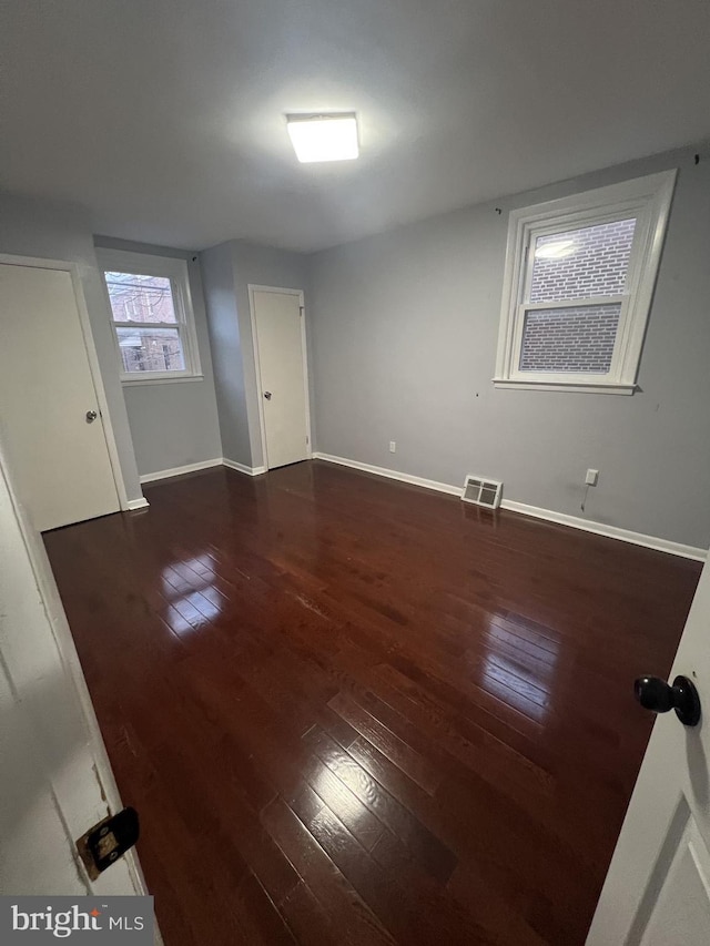 unfurnished room featuring dark hardwood / wood-style floors