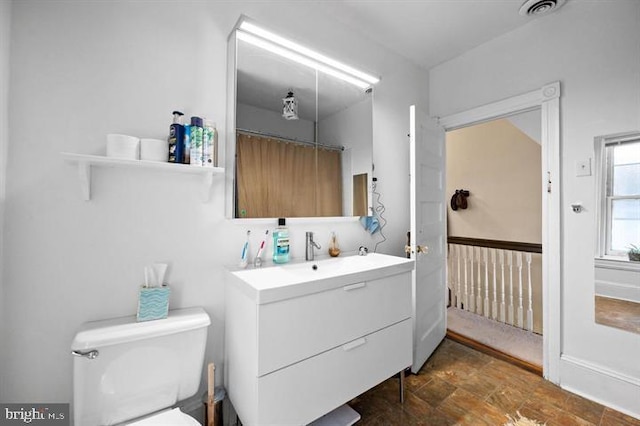 257-9 S 46th St, Philadelphia, PA 19139 - bathroom with toilet, visible vents, vanity, and stone finish flooring