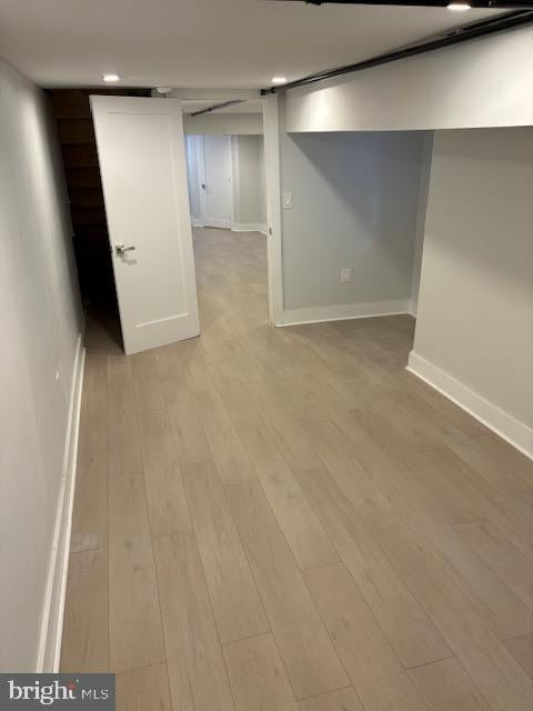 basement with light hardwood / wood-style floors