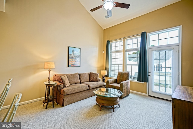 carpeted living room featuring ceiling fan and high vaulted ceiling