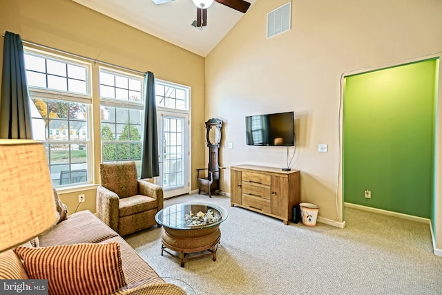 sitting room with light carpet, high vaulted ceiling, a wealth of natural light, and ceiling fan