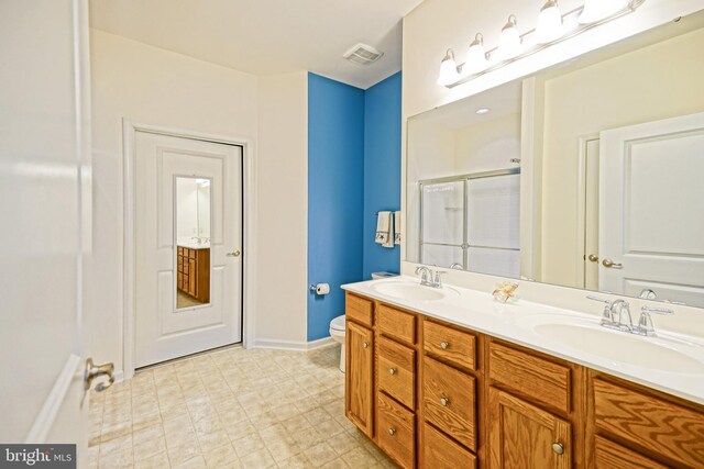 bathroom with vanity, toilet, and walk in shower