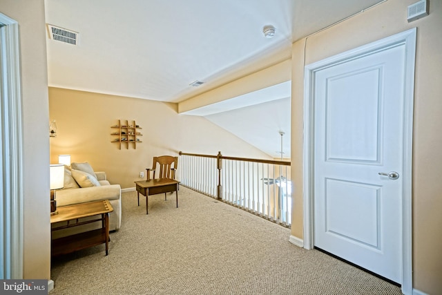 living area with carpet and vaulted ceiling