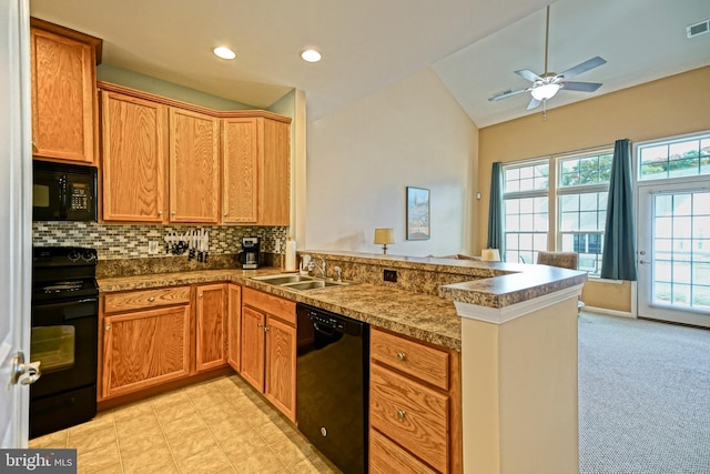 kitchen with backsplash, kitchen peninsula, black appliances, and vaulted ceiling