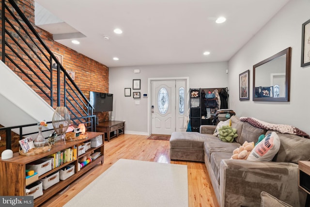 living area featuring stairs, recessed lighting, wood finished floors, and baseboards