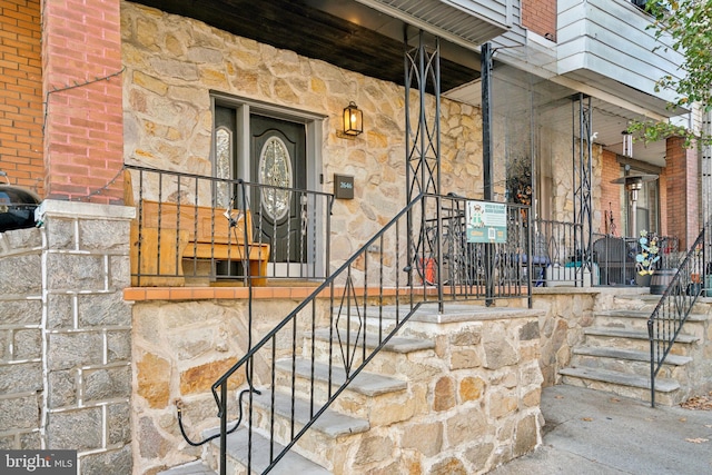 property entrance with stone siding