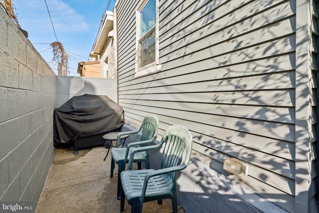 view of patio / terrace featuring grilling area and fence