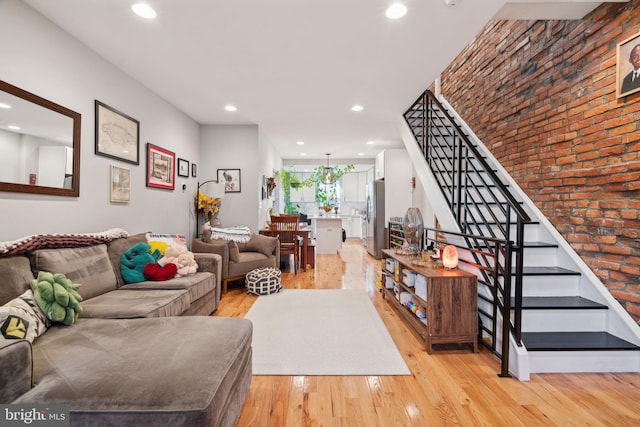 living room featuring recessed lighting, stairway, and light wood finished floors