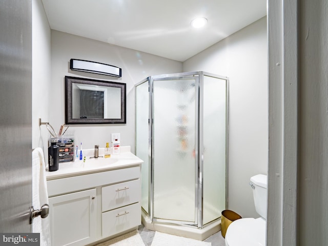 bathroom with toilet, a shower with shower door, and vanity