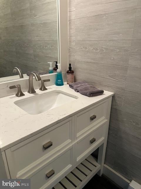 bathroom with tile walls and vanity