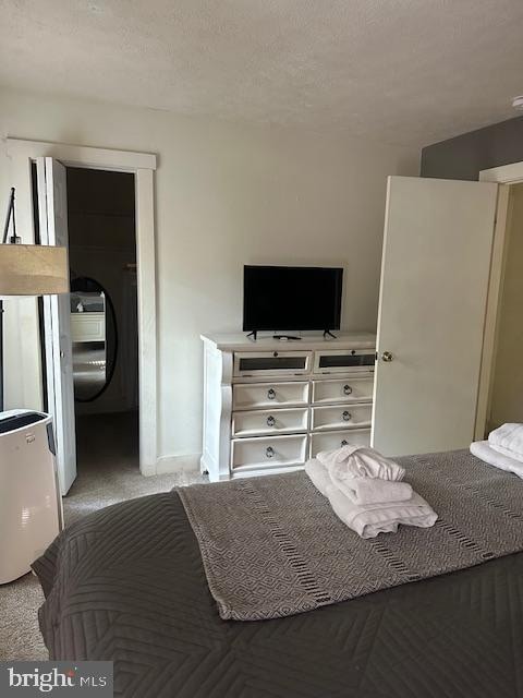 bedroom featuring a textured ceiling and carpet floors