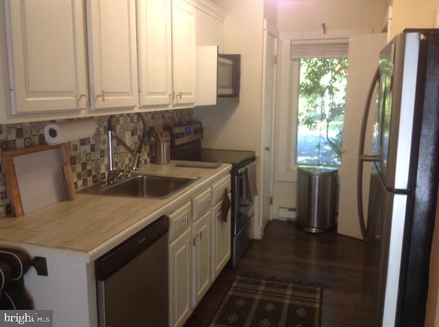 kitchen featuring white cabinetry, fridge, dishwasher, black range with electric cooktop, and sink