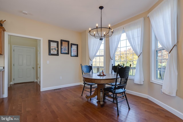 dining area with an inviting chandelier and dark hardwood / wood-style floors