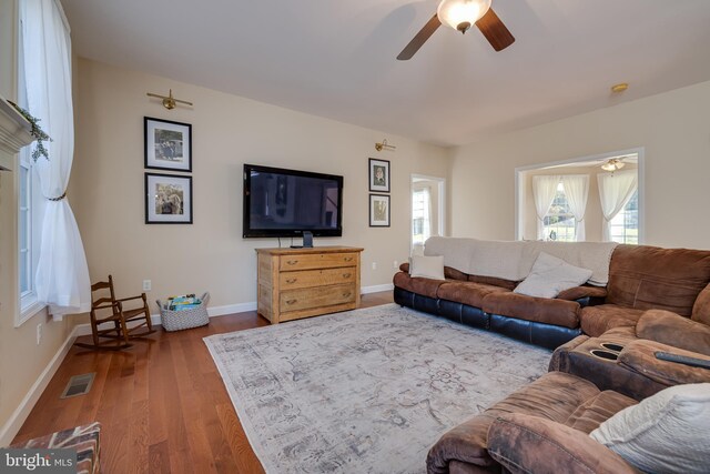 living room with wood-type flooring and ceiling fan