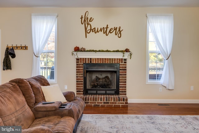 living room with hardwood / wood-style flooring and a fireplace