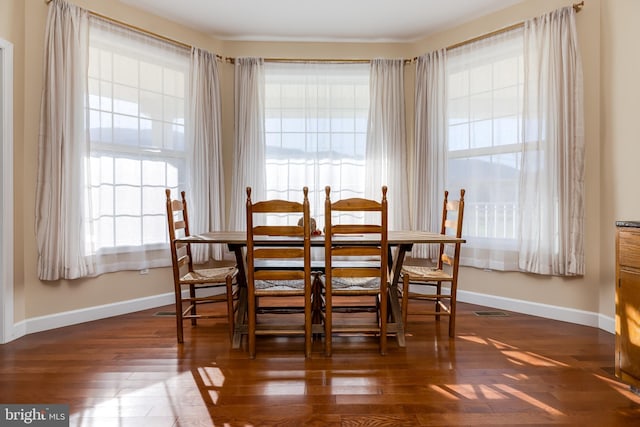 dining area featuring dark hardwood / wood-style floors