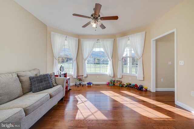 interior space with dark hardwood / wood-style floors and ceiling fan