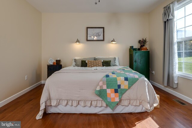 bedroom with hardwood / wood-style floors