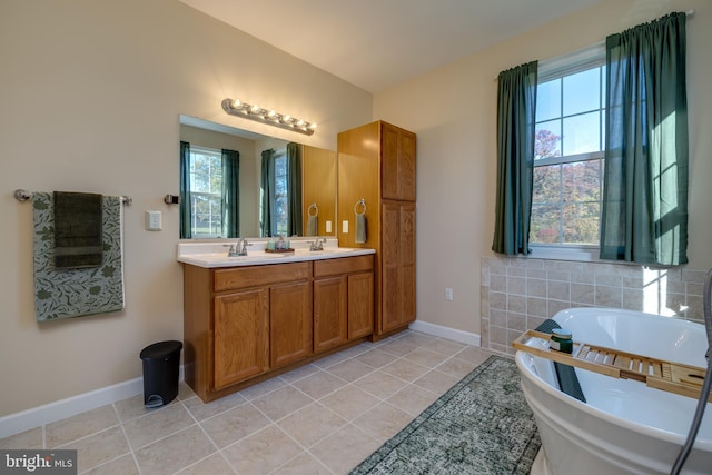 bathroom featuring vanity, a tub to relax in, and tile patterned flooring