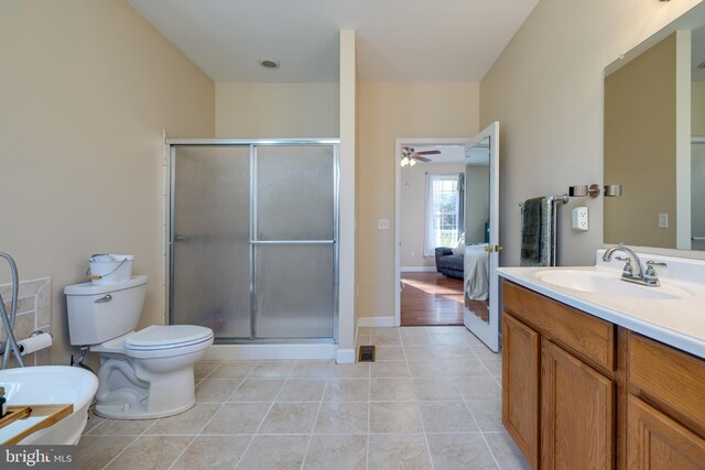 bathroom featuring vanity, toilet, tile patterned floors, and a shower with door