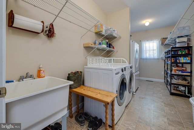 laundry room featuring washer and dryer and sink