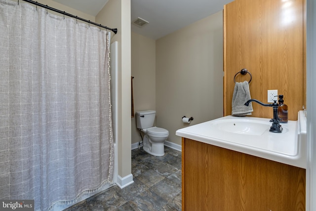 bathroom featuring vanity, toilet, and a shower with shower curtain