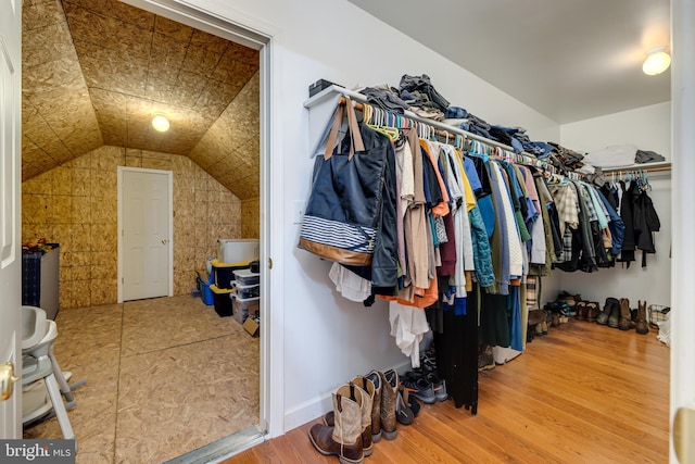 spacious closet featuring wood-type flooring and vaulted ceiling