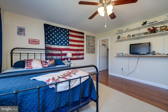 bedroom featuring hardwood / wood-style flooring and ceiling fan