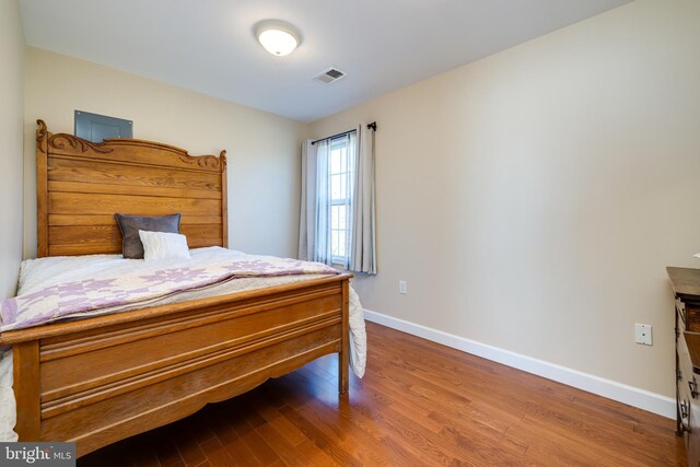 bedroom with hardwood / wood-style floors