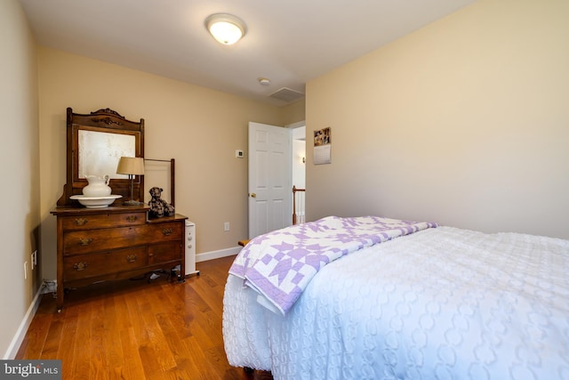 bedroom with hardwood / wood-style floors