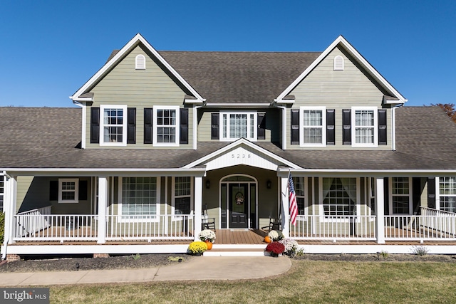 view of front facade with covered porch and a front yard