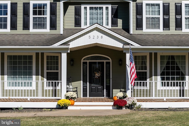 view of exterior entry featuring a porch