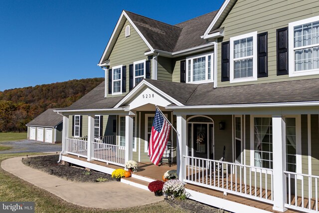 view of front of house featuring a porch and a garage