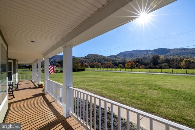 balcony with covered porch, a mountain view, and a rural view