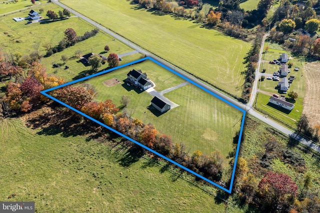 birds eye view of property with a rural view