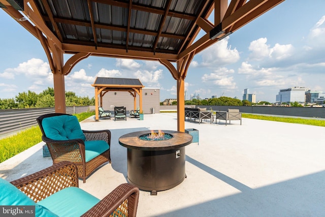 view of patio featuring a gazebo and an outdoor living space with a fire pit